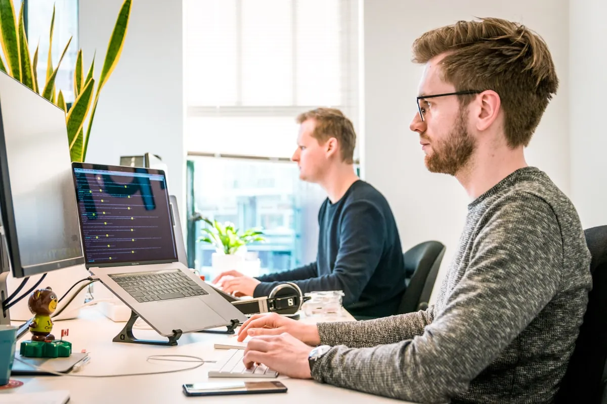 Two team members reviewing a layout on a laptop